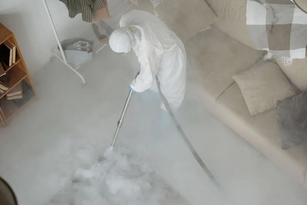 Biohazard cleanup technician in protective equipment, Corydon, IA